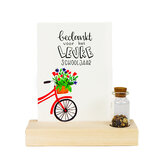 Bedankje zaden in glazen flesje met kaart in standaard