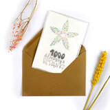 Zaden met ansichtkaart verpakt in pergamijn zakje