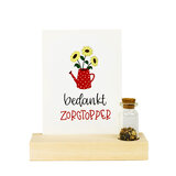 Bedankje zaden in glazen flesje met kaart in standaard